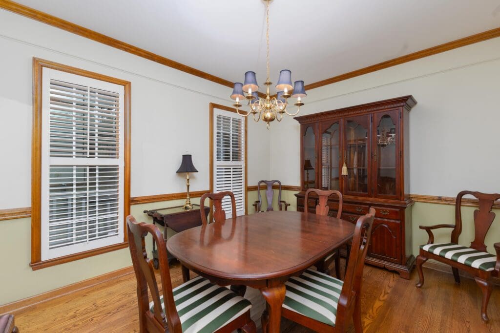 Elegant formal dining room with hardwood floors and natural light.