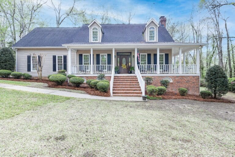 Front exterior view of 145 Ashley Hills Dr, Lexington SC – 4 bedroom, 3 bathroom home with brick accents, hardwood floors inside, and a spacious .79-acre lot for sale.
