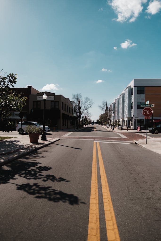 A peaceful urban street in Lakeland, FL with clear skies and minimal traffic.