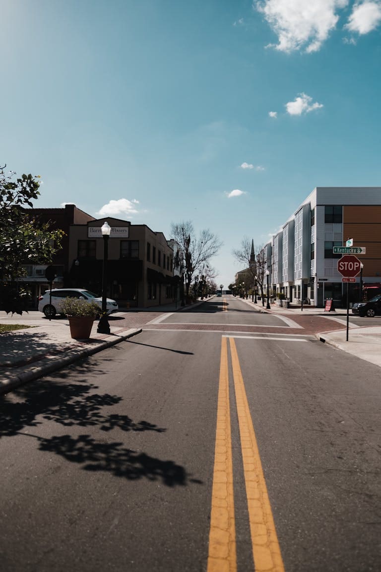 A peaceful urban street in Lakeland, FL with clear skies and minimal traffic.