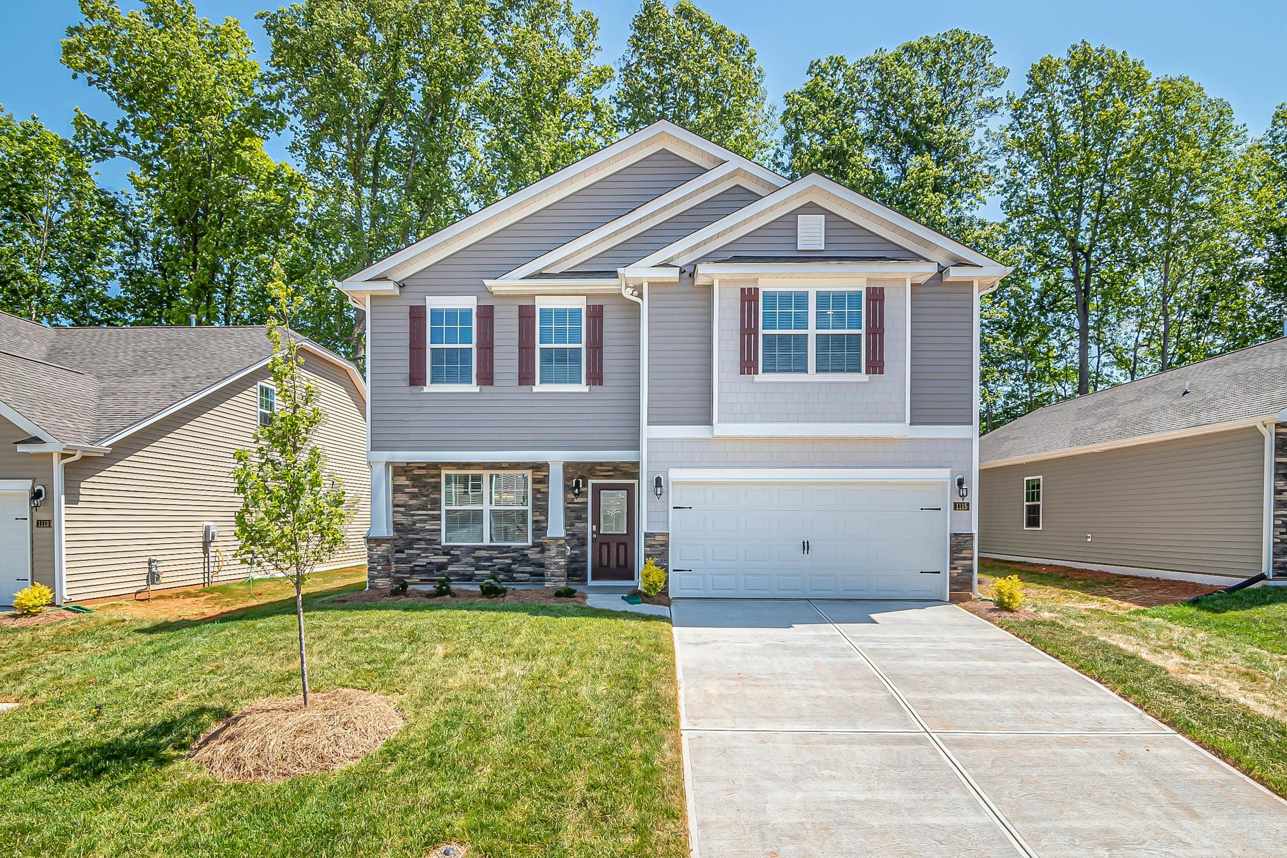 Spacious modern family home with well-maintained front yard in a suburban neighborhood.