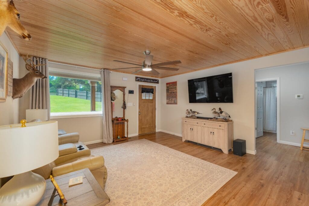 725 Wildwood Road Living Room Photo With Wood Ceilings, LVP flooring and lake views