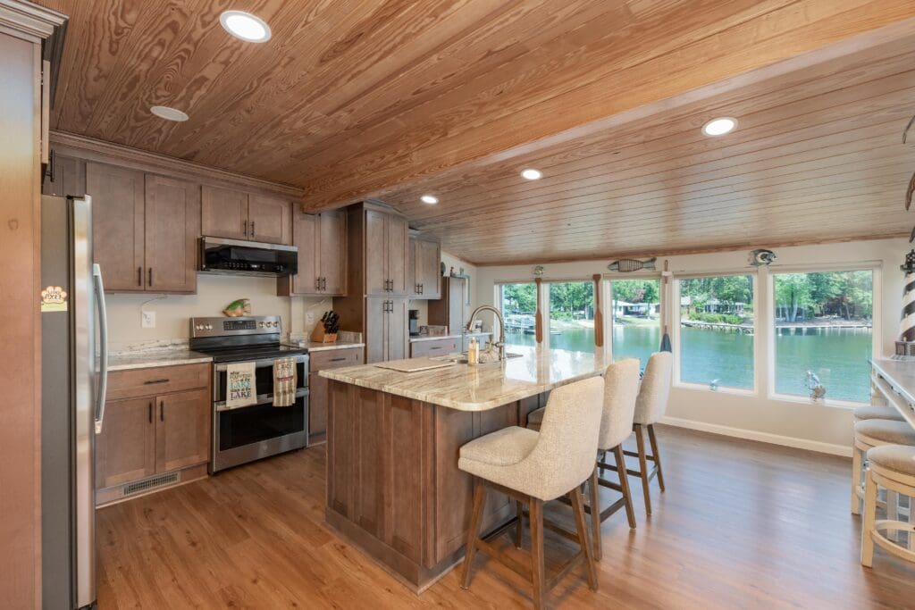 725 Wildwood Road Leesville SC Renovated Kitchen Photo With Stained Cabinets, Island, Granite Countertops, and Lake Views